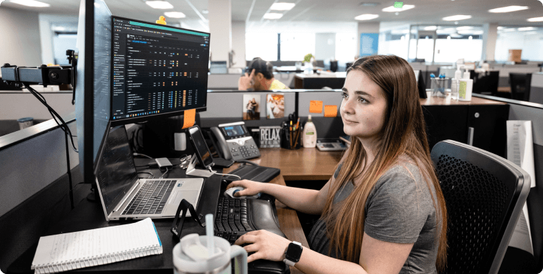 Female Dirt World worker at a computer