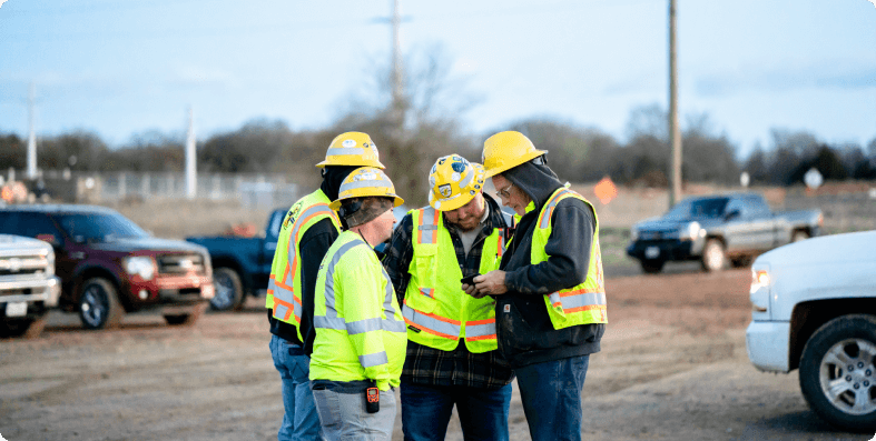 Crew members huddled around a phone